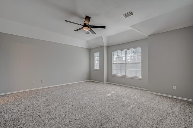 unfurnished room with ceiling fan, vaulted ceiling, and light colored carpet