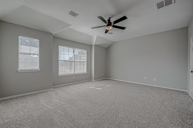 carpeted empty room featuring vaulted ceiling and ceiling fan