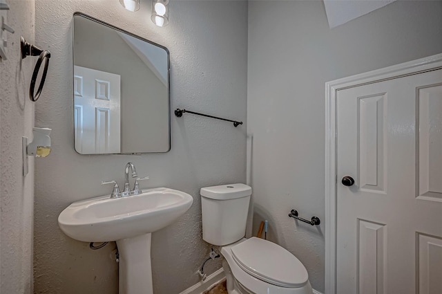 bathroom featuring sink and toilet