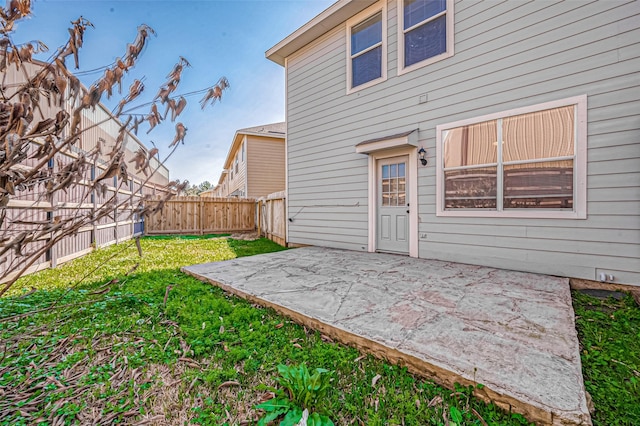 rear view of property featuring a patio area and a lawn