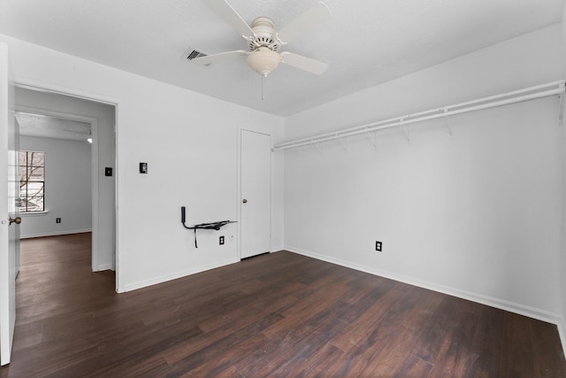 empty room with dark hardwood / wood-style flooring and ceiling fan