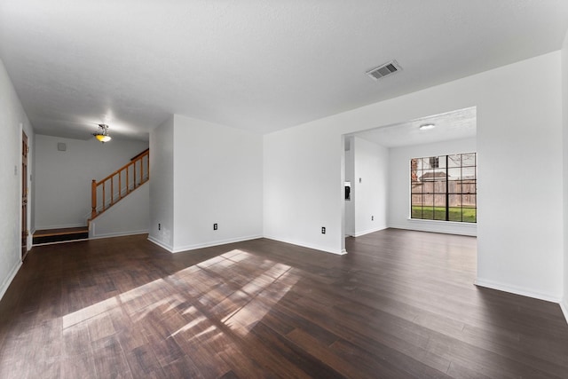 unfurnished room featuring dark wood-type flooring