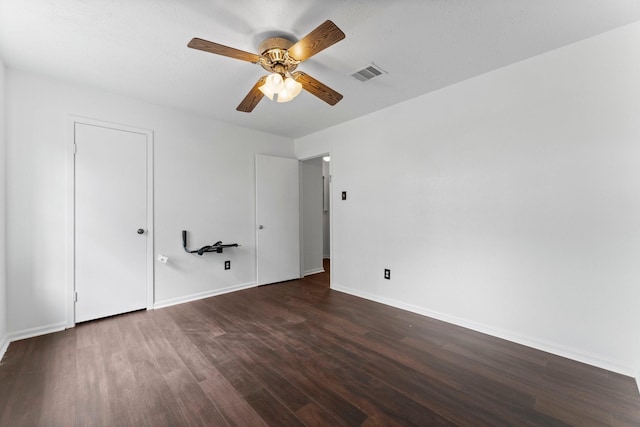 interior space with dark hardwood / wood-style flooring and ceiling fan