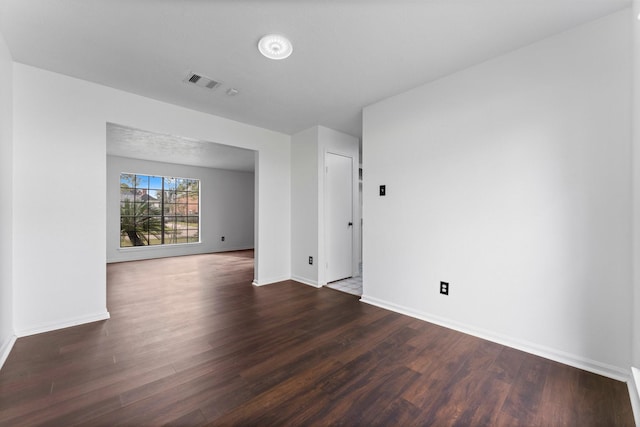 spare room with dark hardwood / wood-style floors