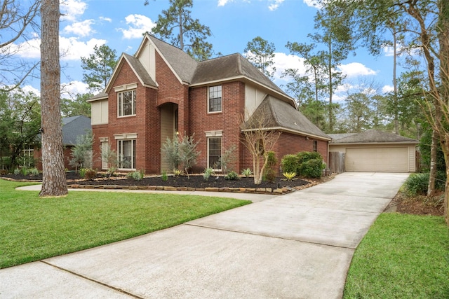 traditional home with brick siding, a front lawn, a detached garage, and a shingled roof