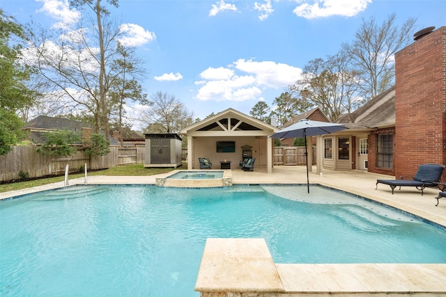 view of swimming pool with a storage shed, a fenced backyard, a patio, and an outdoor structure