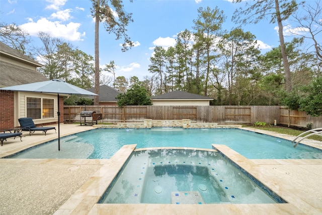 view of swimming pool featuring a patio area, a fenced backyard, a pool with connected hot tub, and a grill