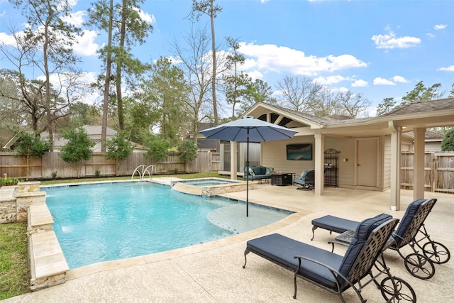 view of swimming pool with a fenced backyard, a pool with connected hot tub, and a patio