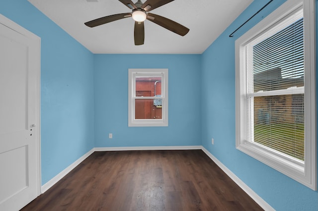 spare room featuring dark hardwood / wood-style floors and ceiling fan