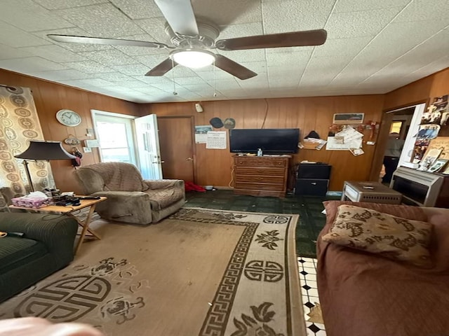 living room with wooden walls and ceiling fan