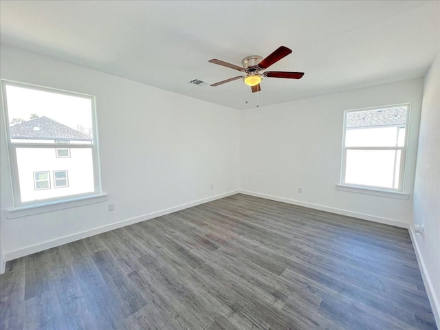 empty room with dark hardwood / wood-style floors and ceiling fan