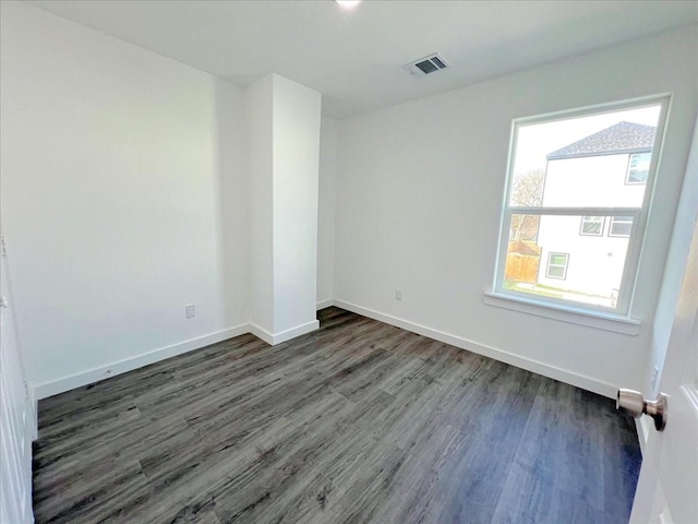 empty room featuring dark wood-type flooring