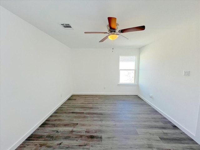 spare room with ceiling fan and dark hardwood / wood-style floors