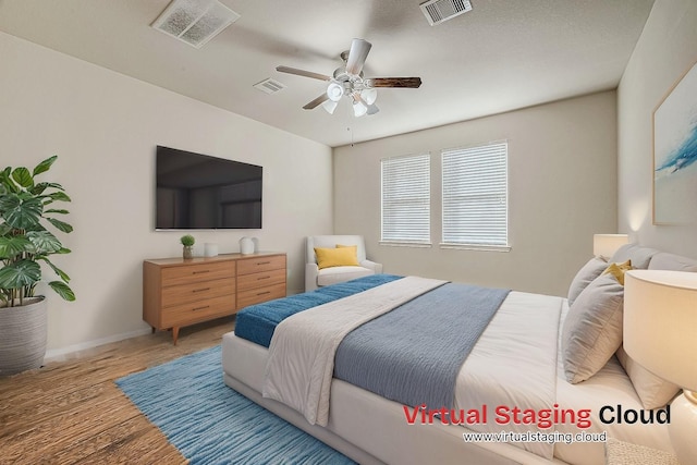 bedroom with wood-type flooring and ceiling fan