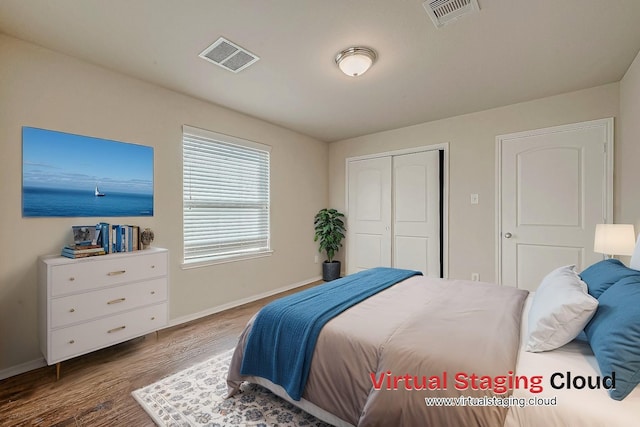 bedroom featuring dark hardwood / wood-style floors and a closet