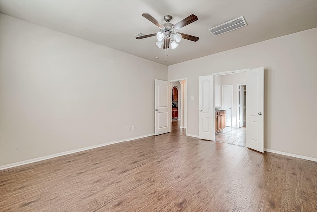 unfurnished bedroom with hardwood / wood-style floors and ceiling fan