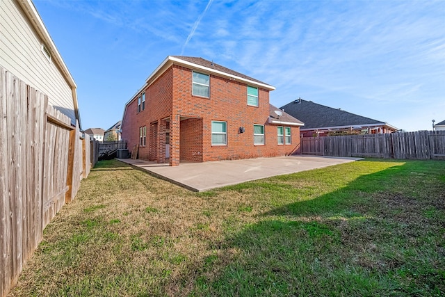 back of property featuring a yard, central AC unit, and a patio area