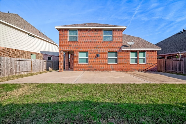 rear view of house featuring a patio and a lawn