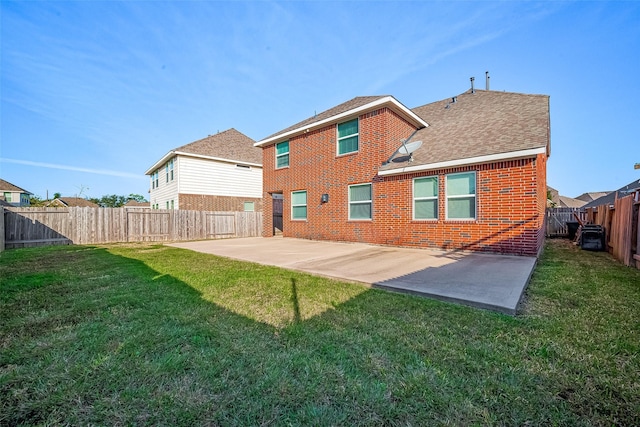 back of house featuring a patio area and a lawn