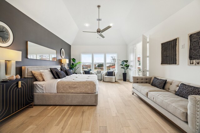 bedroom with visible vents, a ceiling fan, light wood-type flooring, and high vaulted ceiling