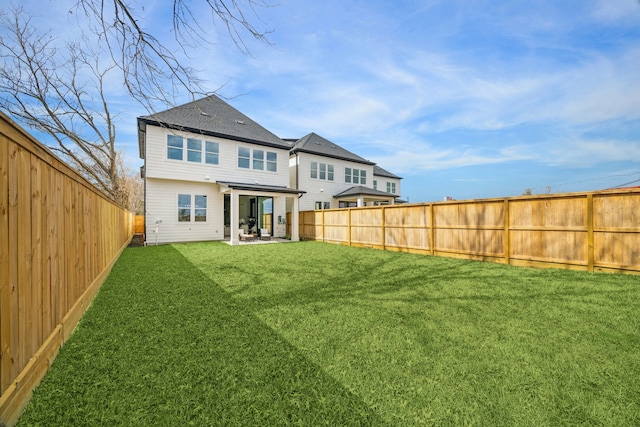 rear view of property featuring a patio area and a yard