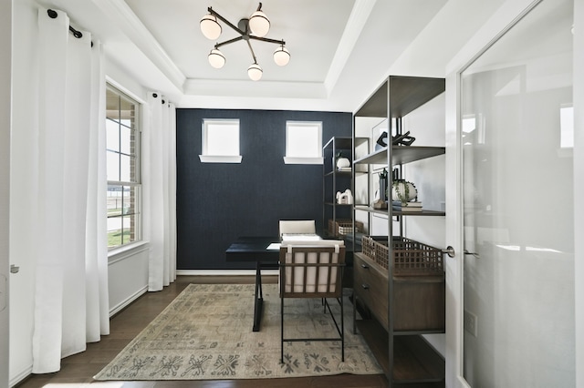 home office with a chandelier, a raised ceiling, and hardwood / wood-style floors