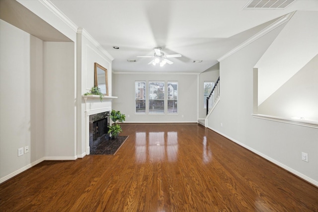 unfurnished living room featuring a premium fireplace, crown molding, dark hardwood / wood-style floors, and ceiling fan