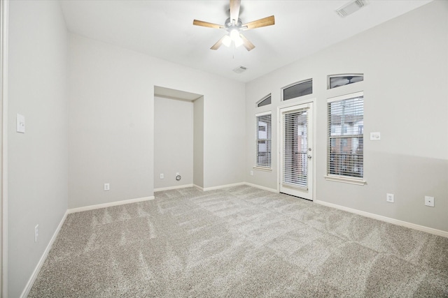 carpeted empty room featuring ceiling fan