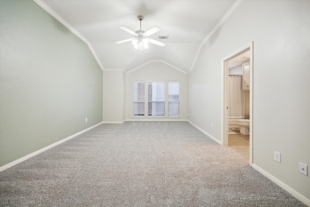 interior space with ceiling fan, vaulted ceiling, and light carpet