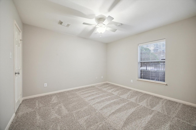 carpeted spare room featuring ceiling fan