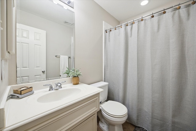 bathroom featuring vanity and toilet