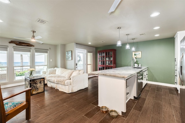 kitchen featuring sink, white cabinetry, kitchen peninsula, pendant lighting, and ceiling fan