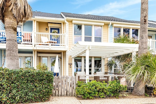 view of front of home with a balcony and a pergola