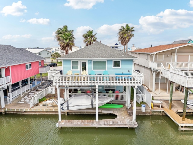 rear view of house featuring a pool side deck with water view