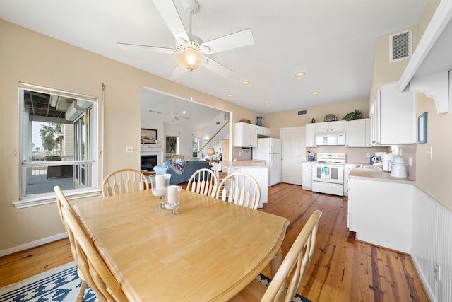 dining area featuring ceiling fan and dark hardwood / wood-style flooring