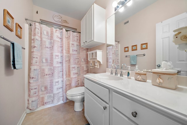 bathroom featuring tile patterned floors, vanity, and toilet