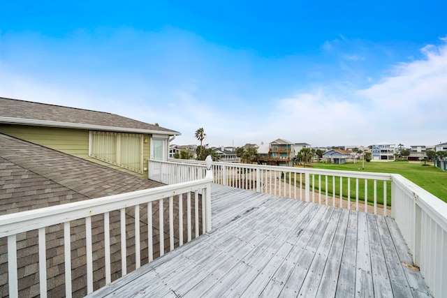 wooden deck featuring a lawn