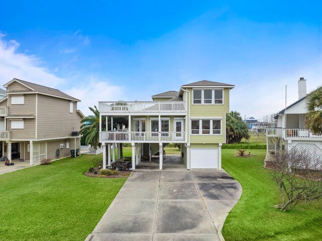 view of front facade featuring a front lawn, a balcony, concrete driveway, an attached garage, and a carport