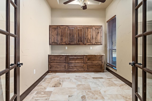 kitchen with ceiling fan, dark brown cabinetry, and french doors