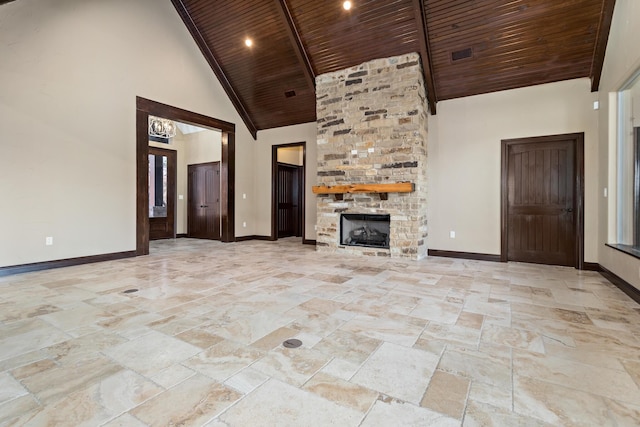 unfurnished living room with high vaulted ceiling, a stone fireplace, and wood ceiling