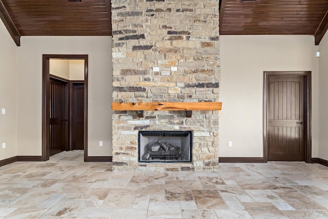 unfurnished living room featuring wood ceiling and a stone fireplace