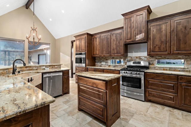 kitchen featuring pendant lighting, stainless steel appliances, sink, and dark brown cabinets