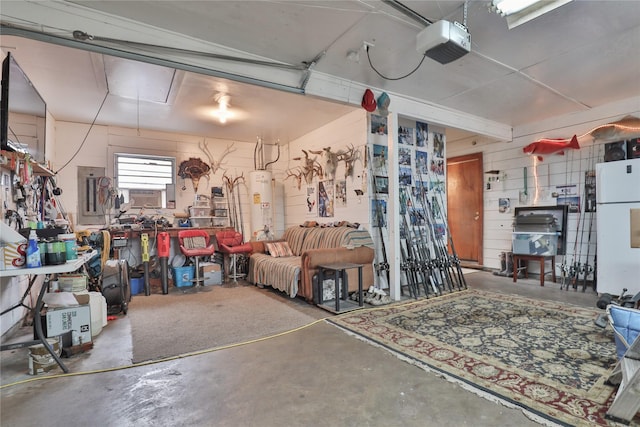 garage featuring a garage door opener, gas water heater, white fridge, and a workshop area