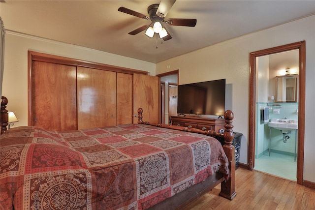 bedroom featuring connected bathroom, crown molding, a closet, ceiling fan, and light hardwood / wood-style floors