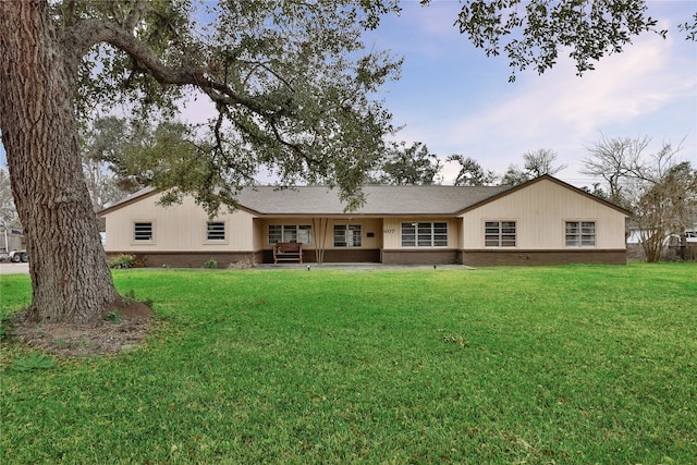 rear view of house featuring a yard