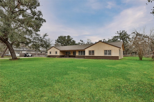 ranch-style home with a front lawn