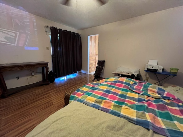 bedroom with dark wood-type flooring and ceiling fan