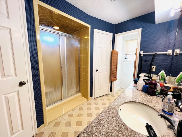 bathroom featuring vanity and an enclosed shower