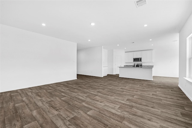 unfurnished living room featuring dark wood-type flooring