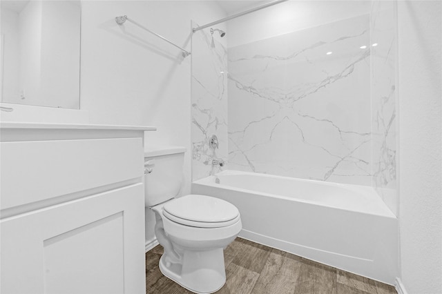 full bathroom featuring vanity, hardwood / wood-style floors, toilet, and tiled shower / bath